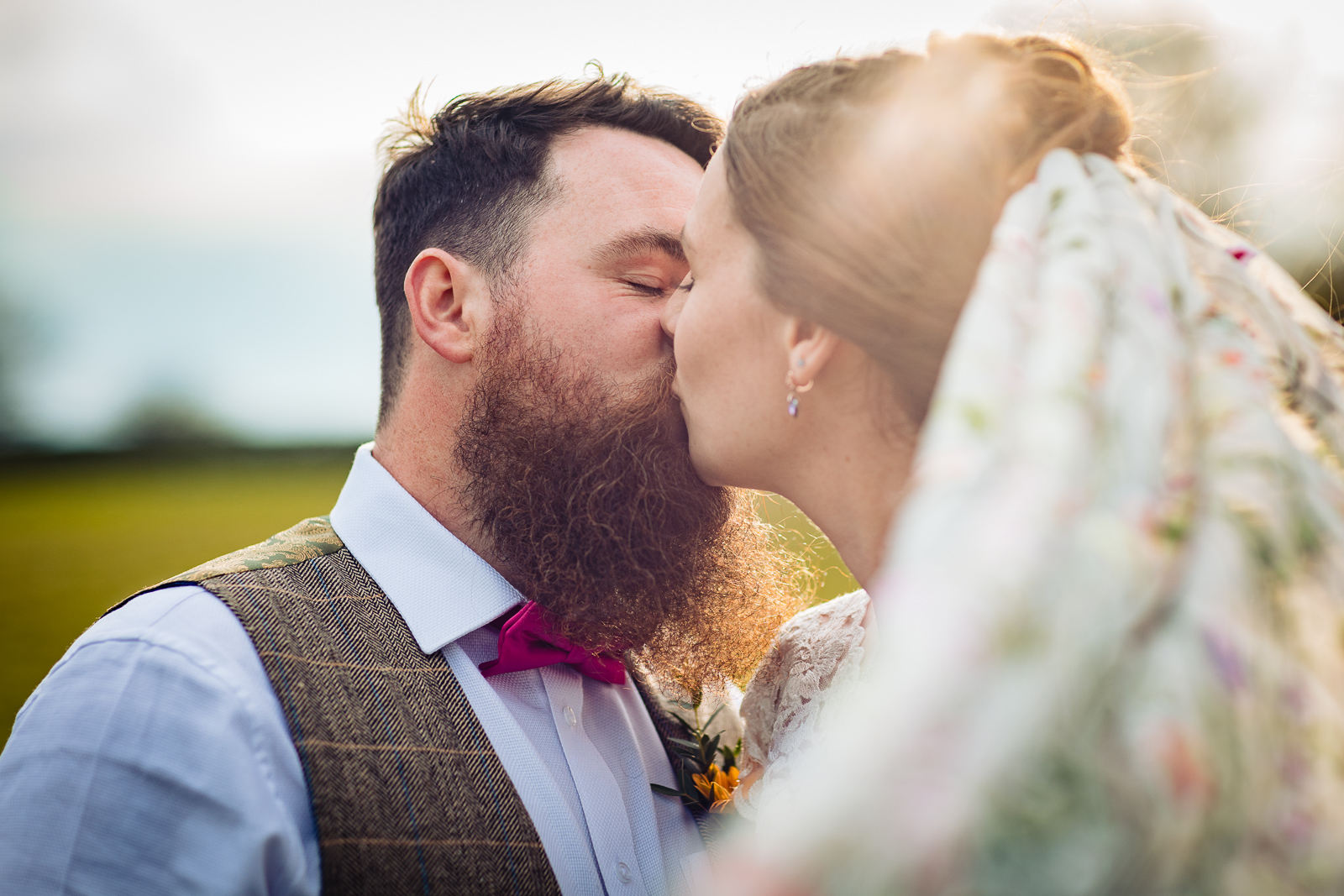20220411-Beautifullight_WeddingPhotography220411-35 close up of bride and groom with a beard kissing