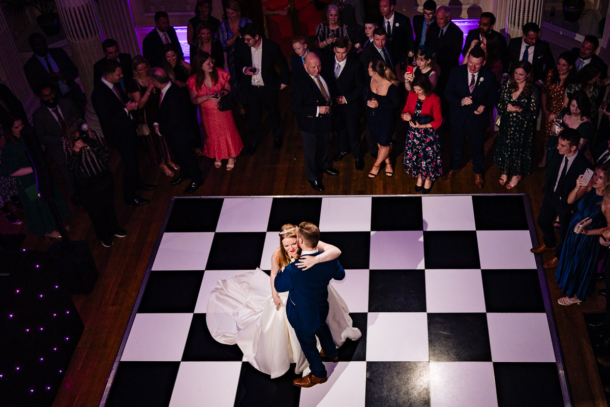 Overhead photo of a happy bride & groom during their 1st dance on the black & white dancefloor at Hedsor House