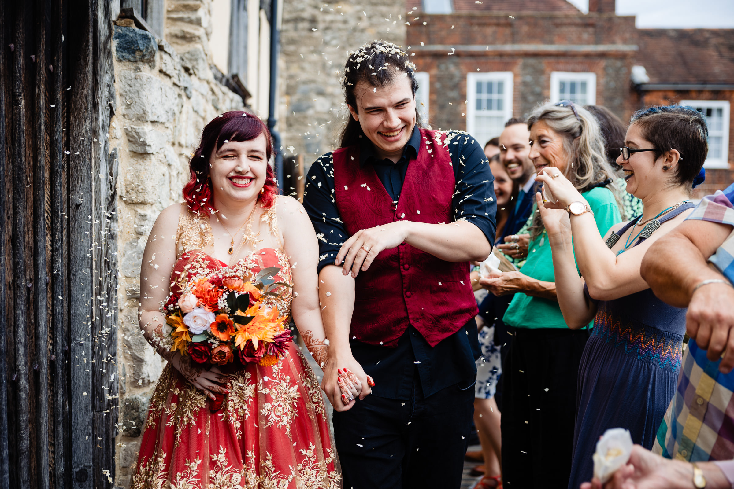 A LGBT couple walk through confetti outside of their wedding venue in Southampton, Hampshire
