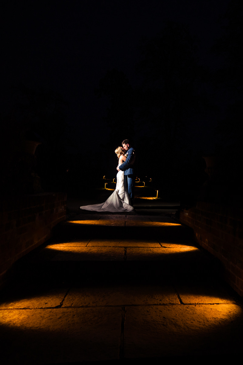 Beautifullightukphotography-6412240418 After dark portrait of a bride & groom on the path in the grounds at Wasing Park. Photographed using off camera flash by Beautifullight photography