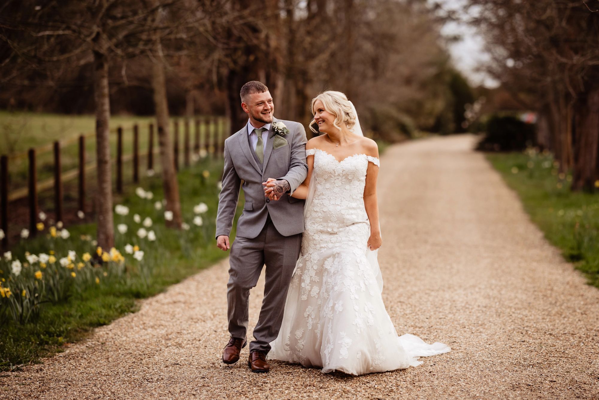 Natural couple portrait walking among spring flowers at the Wellington Arms, Hampshire