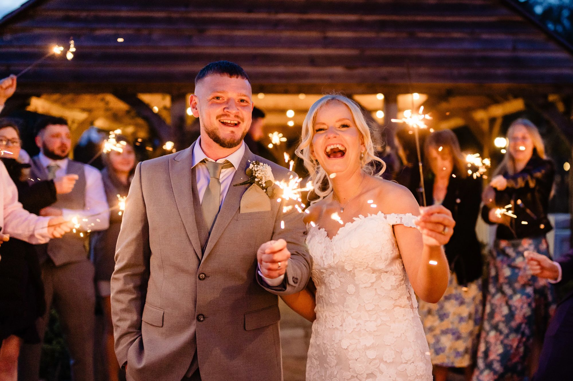 Sparkler exit with bride and groom at evening wedding celebration